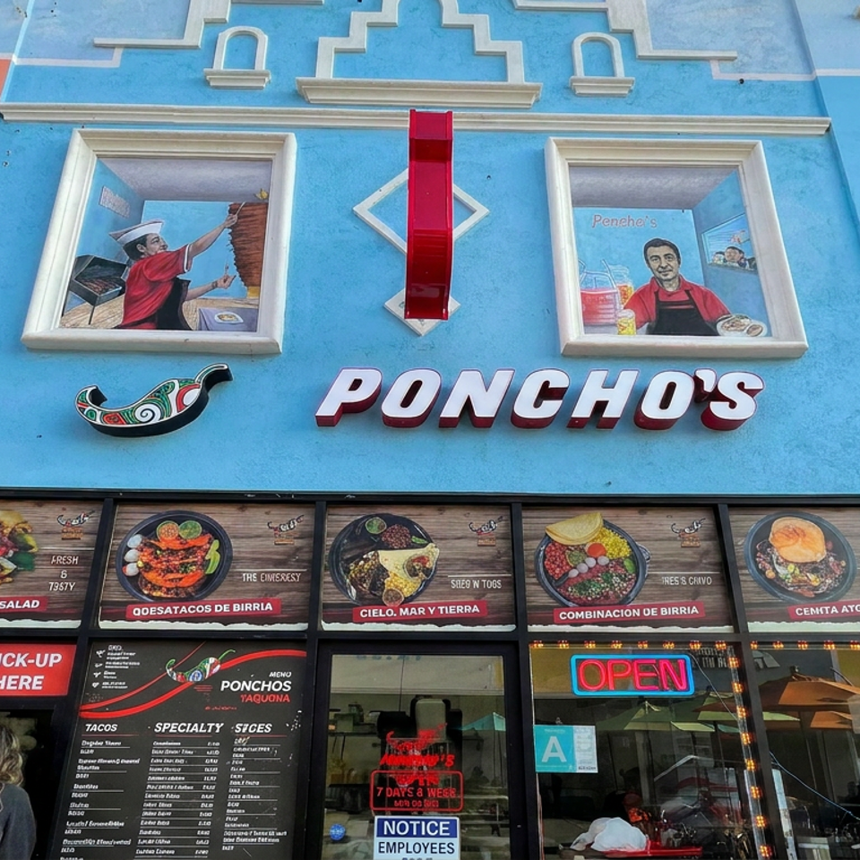 Colorful Poncho’s Mexican restaurant facade with food murals, menu displays, order window, and glowing open sign.